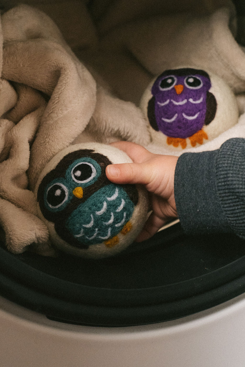 Purple Owl wool dryer ball, in use photo