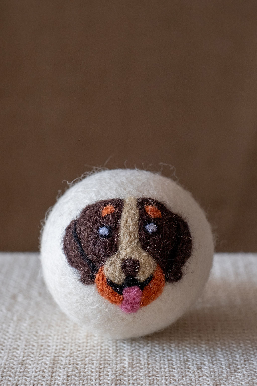 Brown Dog wool dryer ball, studio photo