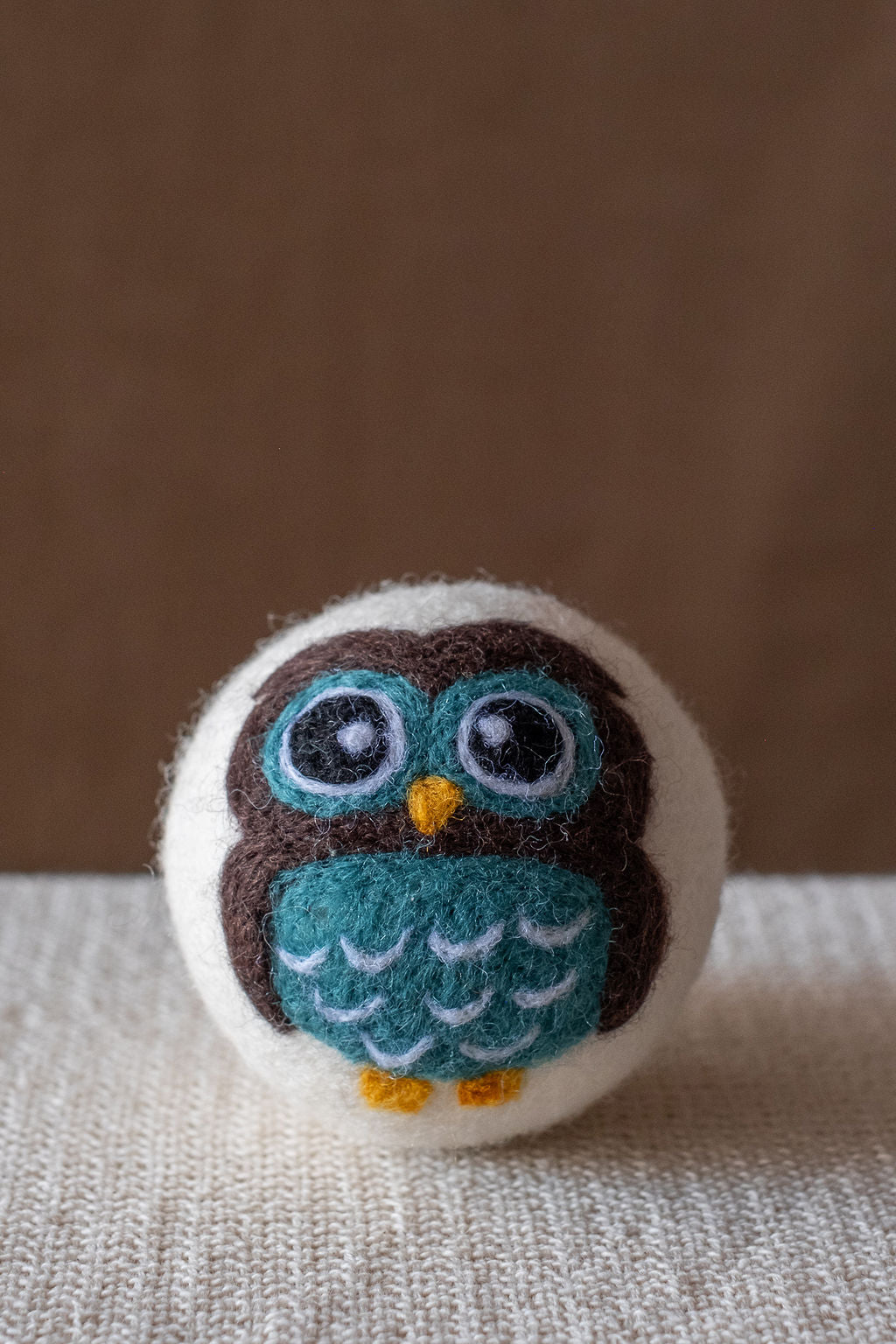 Blue Owl wool dryer ball, studio photo