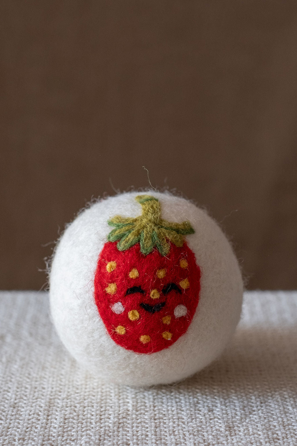 Strawberry wool dryer ball, studio photo
