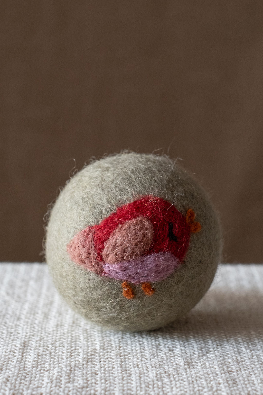 Red Bird wool dryer ball, studio photo