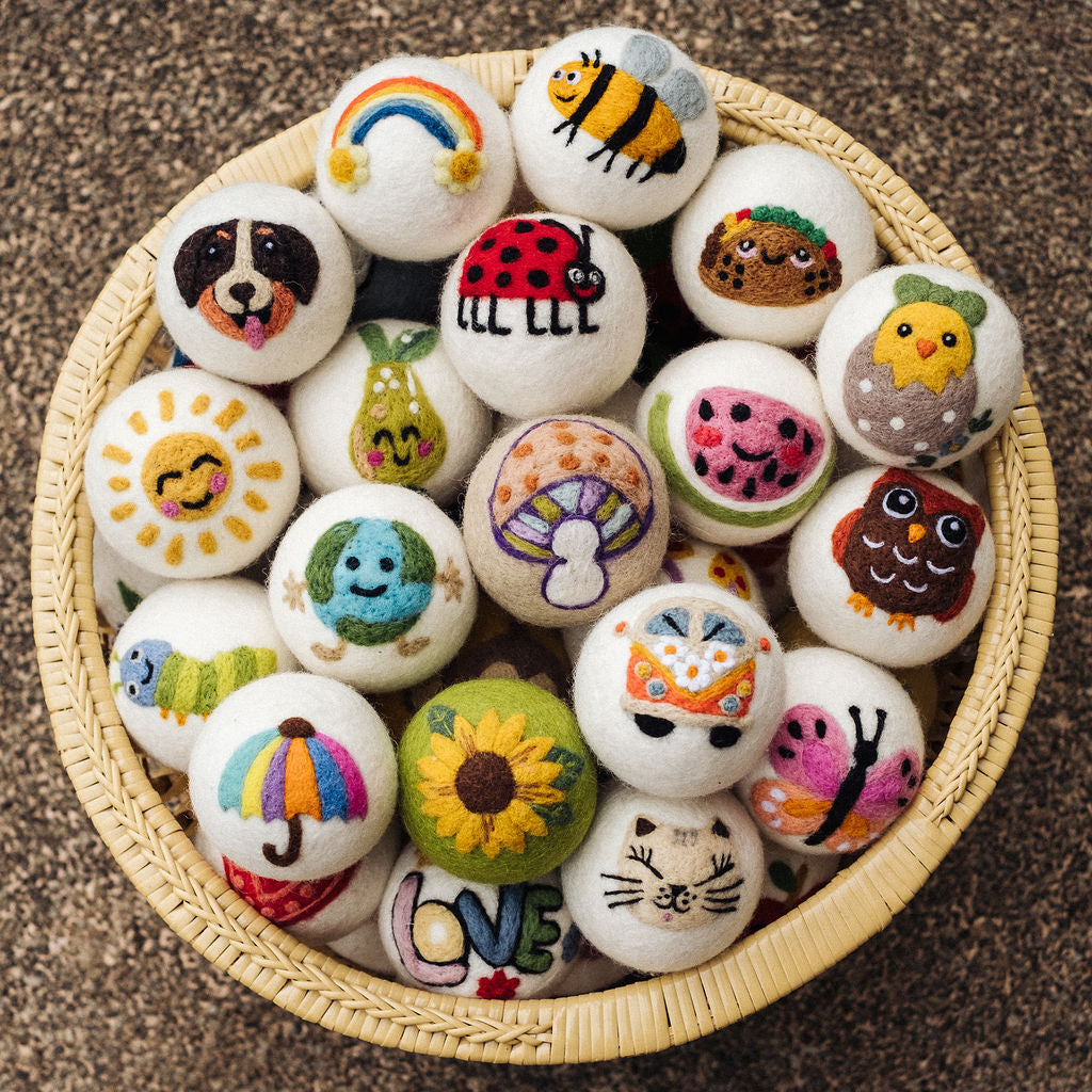 A round basket of wool dryer balls in many designs
