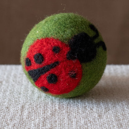 Lady Bug on Green Ball wool dryer ball, square crop